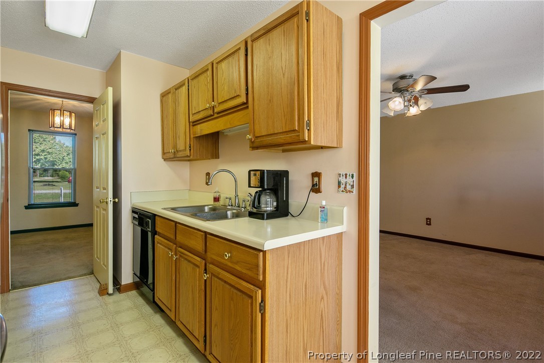 7455 Elliott Bridge Road Spring Lake, NC 28390 - Photo 20 of 49 a kitchen with stainless steel appliances granite countertop a sink and cabinets