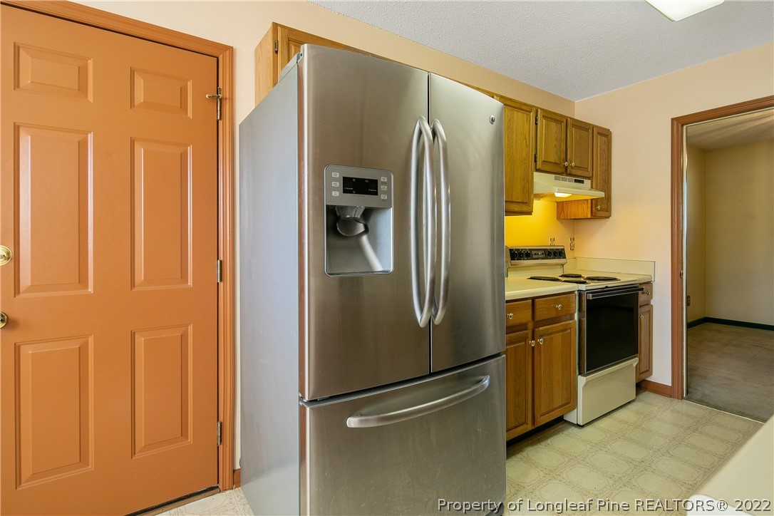 7455 Elliott Bridge Road Spring Lake, NC 28390 - Photo 22 of 49 a kitchen with stainless steel appliances granite countertop a refrigerator and a stove