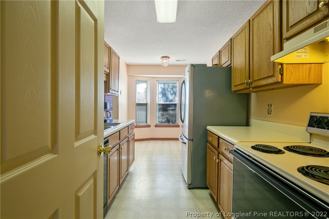 7455 Elliott Bridge Road Spring Lake, NC 28390 - Photo 24 of 49 a kitchen with a stove and a refrigerator