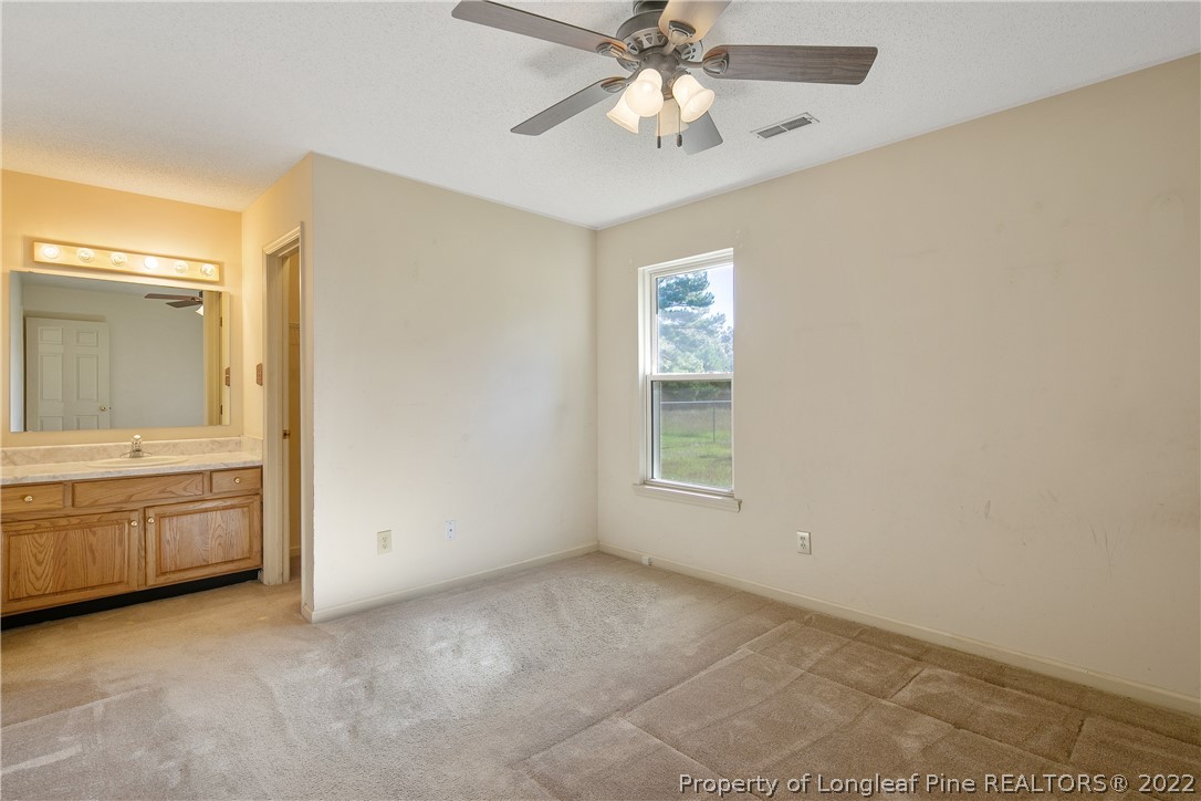 7455 Elliott Bridge Road Spring Lake, NC 28390 - Photo 26 of 49 an empty room with windows and cabinet