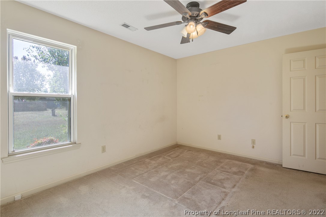7455 Elliott Bridge Road Spring Lake, NC 28390 - Photo 27 of 49 an empty room with a window and a fan