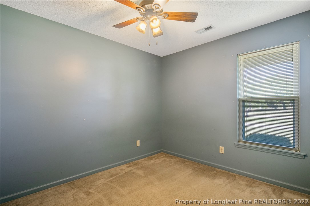 7455 Elliott Bridge Road Spring Lake, NC 28390 - Photo 34 of 49 an empty room with a window and a fan