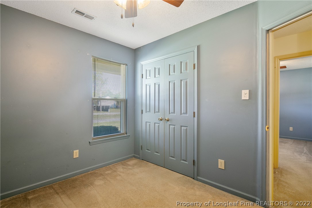 7455 Elliott Bridge Road Spring Lake, NC 28390 - Photo 35 of 49 an empty room with windows and closet