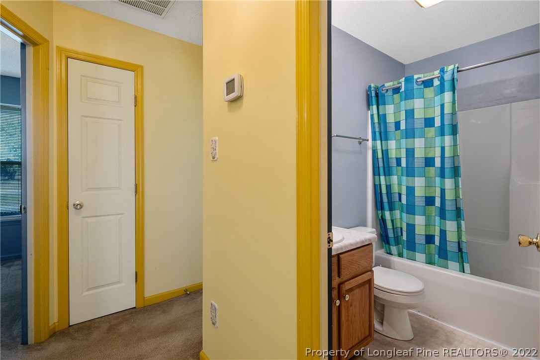 7455 Elliott Bridge Road Spring Lake, NC 28390 - Photo 38 of 49 a bathroom with a toilet a sink and shower