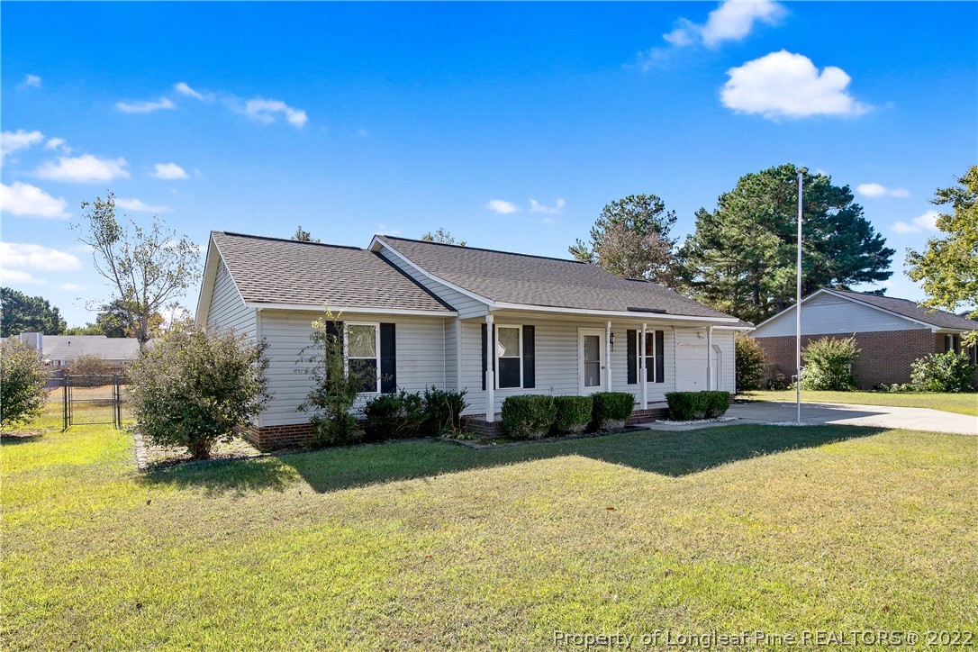 7455 Elliott Bridge Road Spring Lake, NC 28390 - Photo 5 of 49 a front view of a house with garden