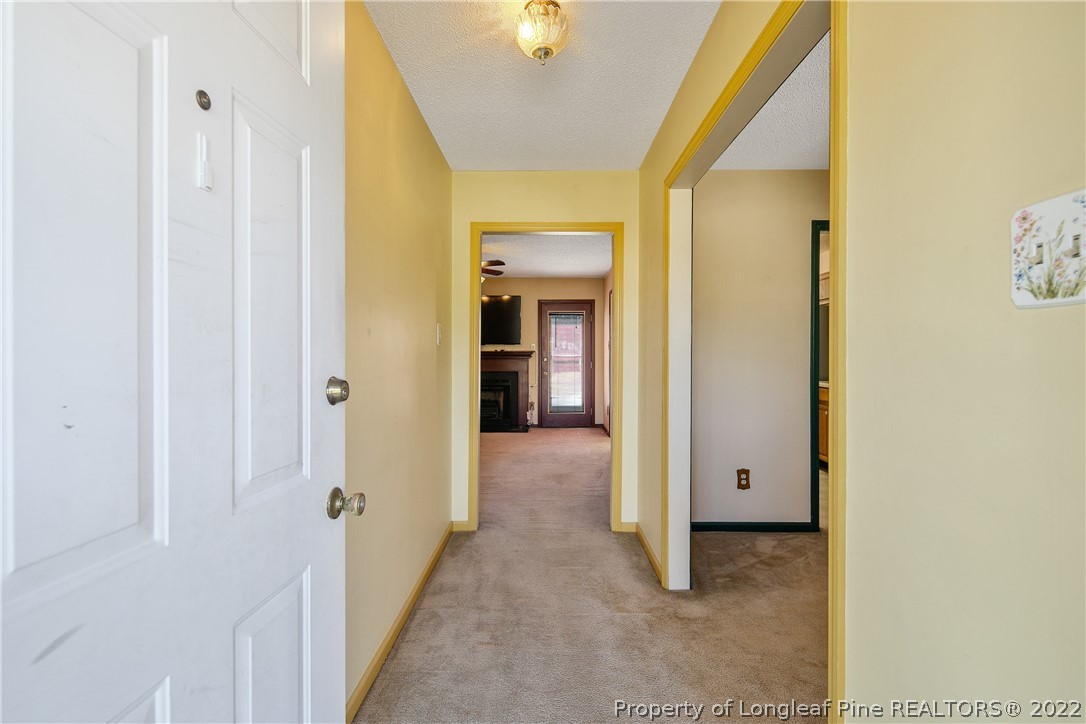 7455 Elliott Bridge Road Spring Lake, NC 28390 - Photo 6 of 49 a view of a hallway with wooden shelves