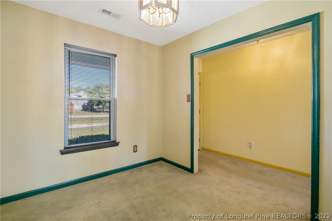 7455 Elliott Bridge Road Spring Lake, NC 28390 - Photo 10 of 49 a view of a small space with wooden floor and a window