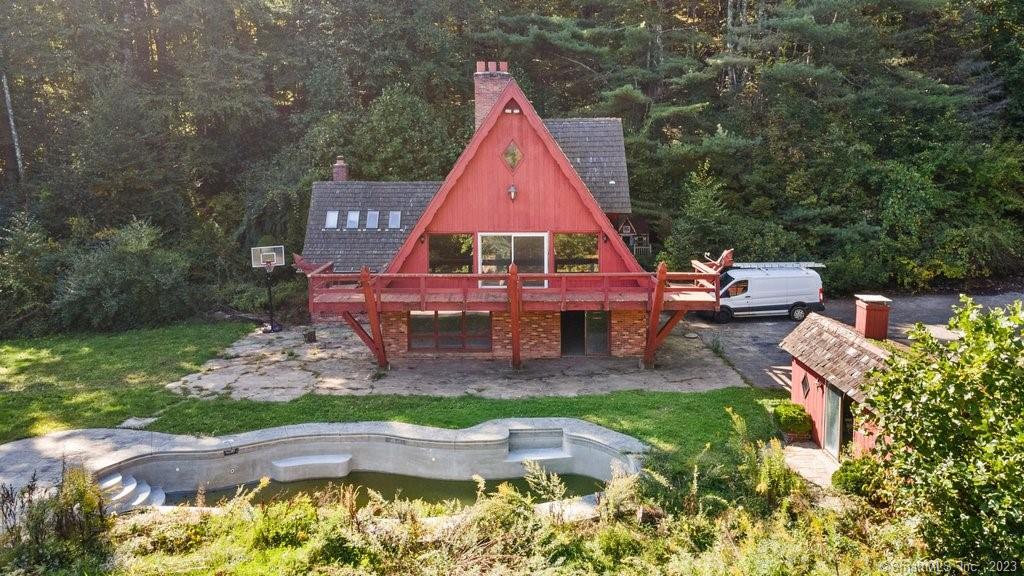an aerial view of a house with swimming pool and garden