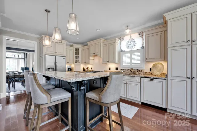 a kitchen with granite countertop a sink cabinets and window