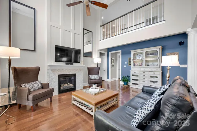 a living room with furniture a fireplace and a flat screen tv