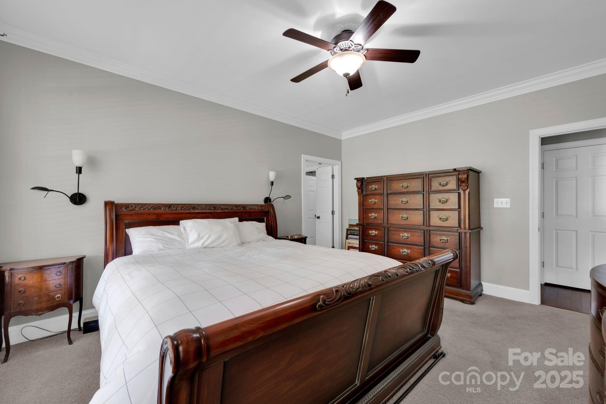 19577 Meta Road Cornelius, NC 28031 - Photo 20 of 45 a bed room with a bed and a chandelier