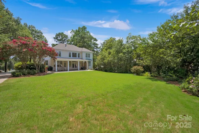 a front view of house with yard and trees