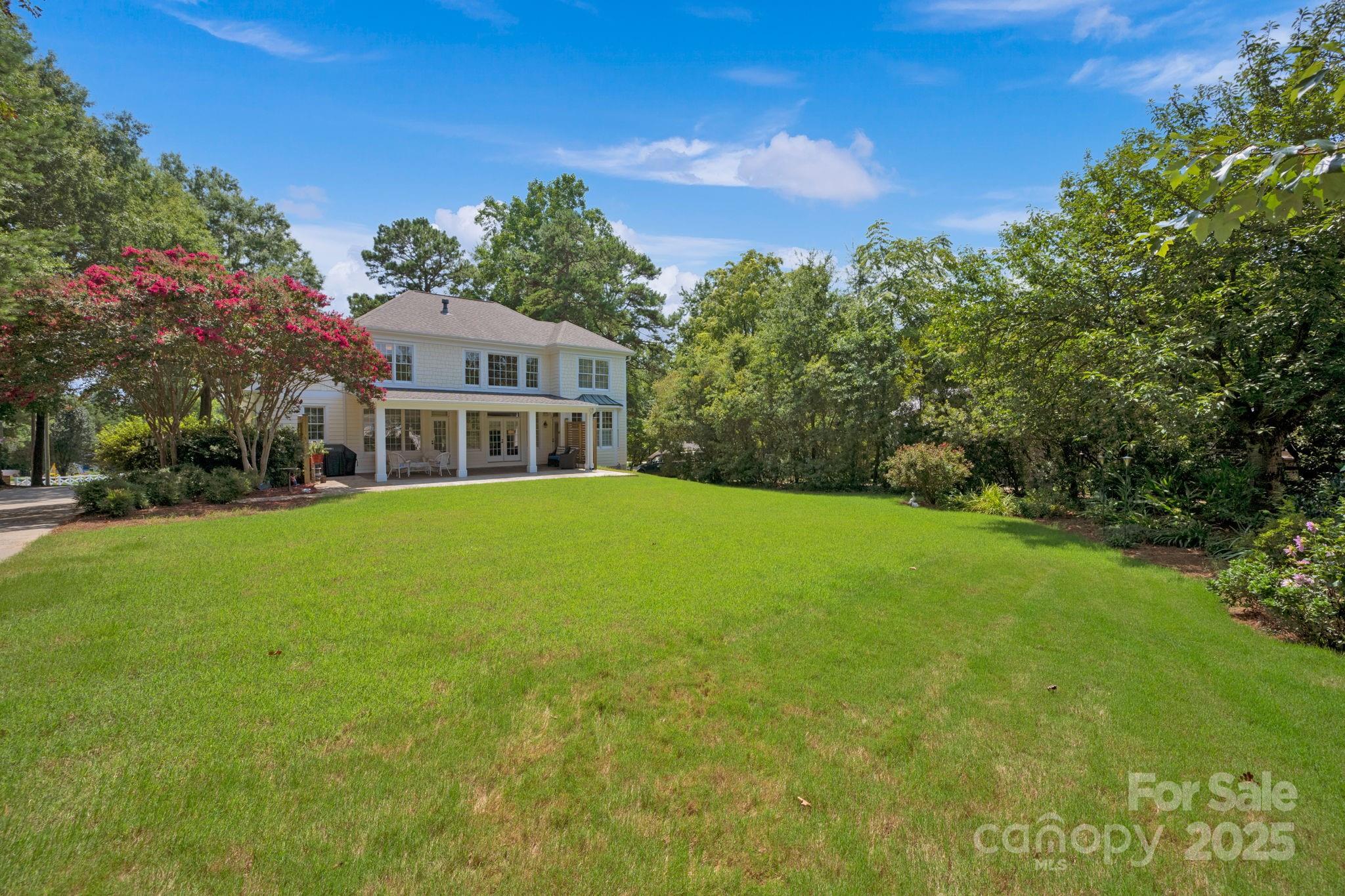 19577 Meta Road Cornelius, NC 28031 - Photo 2 of 45 a front view of house with yard and trees