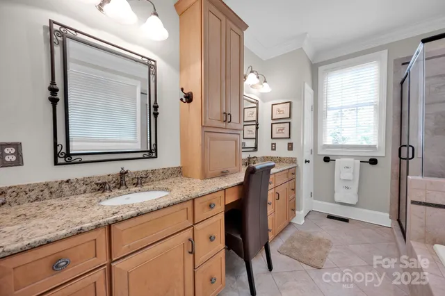 a spacious bathroom with a granite countertop tub sink and mirror