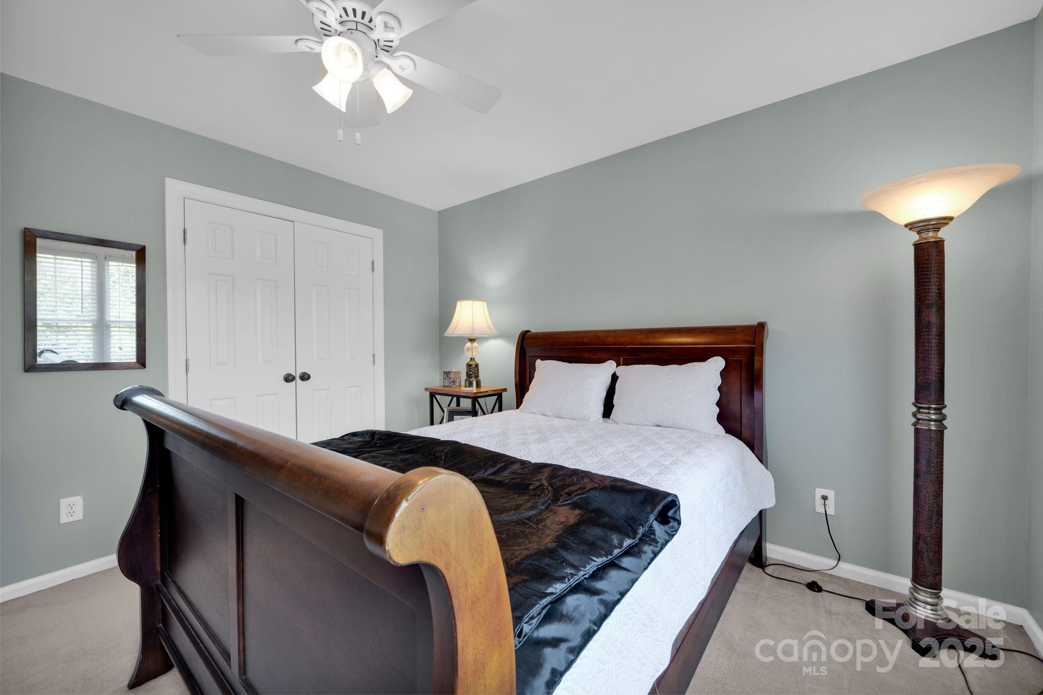 19577 Meta Road Cornelius, NC 28031 - Photo 25 of 45 a bedroom with a bed and a chandelier