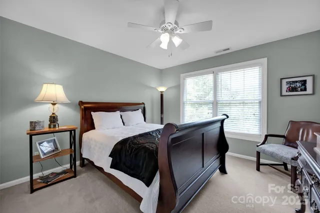 a spacious bedroom with a bed and a window