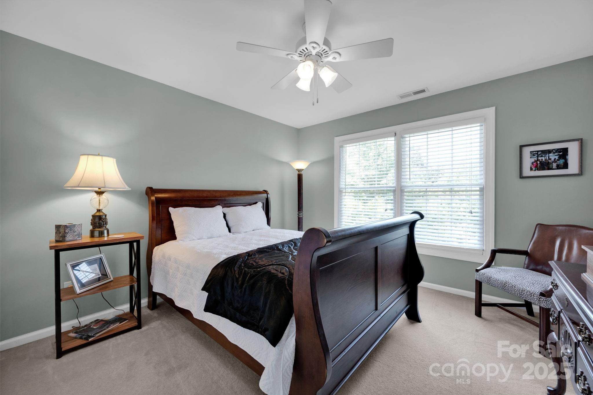 19577 Meta Road Cornelius, NC 28031 - Photo 26 of 45 a spacious bedroom with a bed and a window