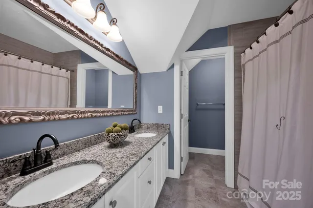 a bathroom with double sink and a mirror