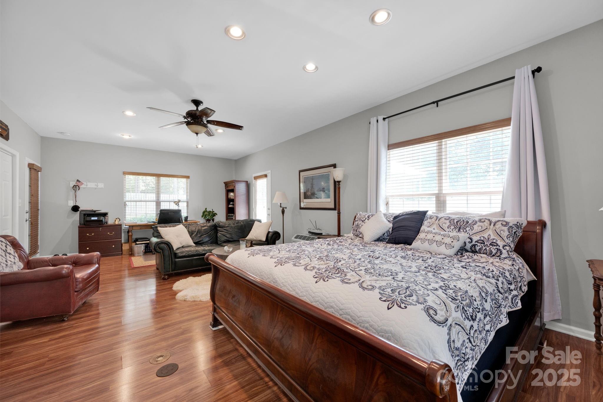 19577 Meta Road Cornelius, NC 28031 - Photo 37 of 45 a bedroom with a large bed and a couch
