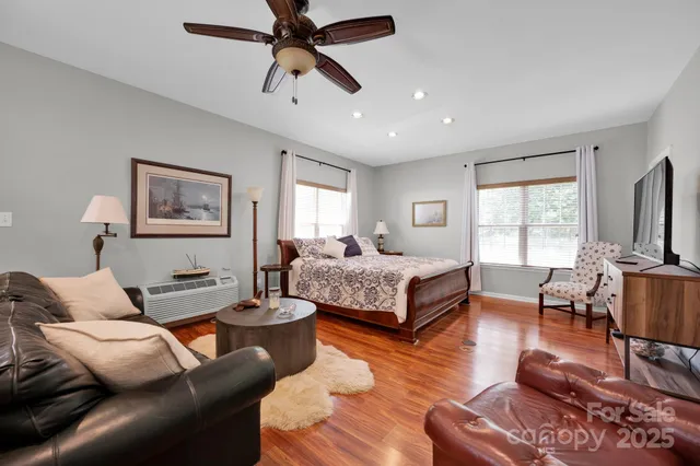 a bedroom with a bed a couch and a window