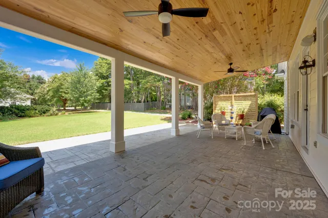 a view of a patio with a table chairs and a backyard