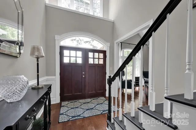 a view of entryway livingroom and hall with wooden floor