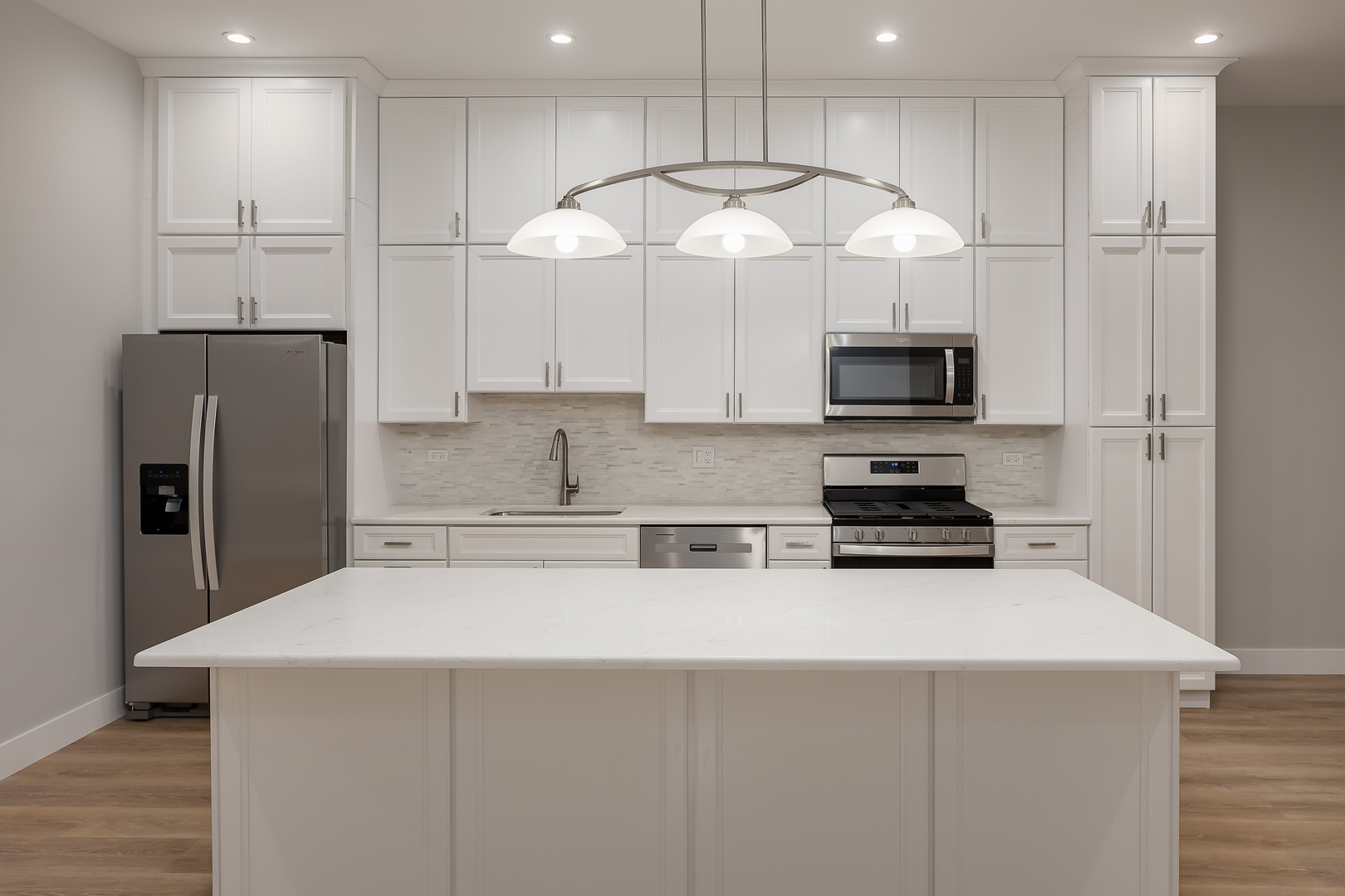 864 North State Street, Unit 2 Chicago, IL 60610 - Photo 8 of 21 a kitchen with stainless steel appliances a refrigerator a stove a microwave and white cabinets