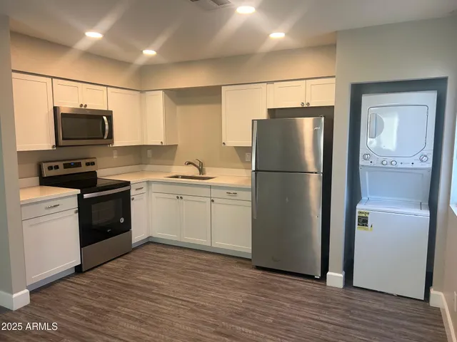 a kitchen with a refrigerator stove and wooden cabinets