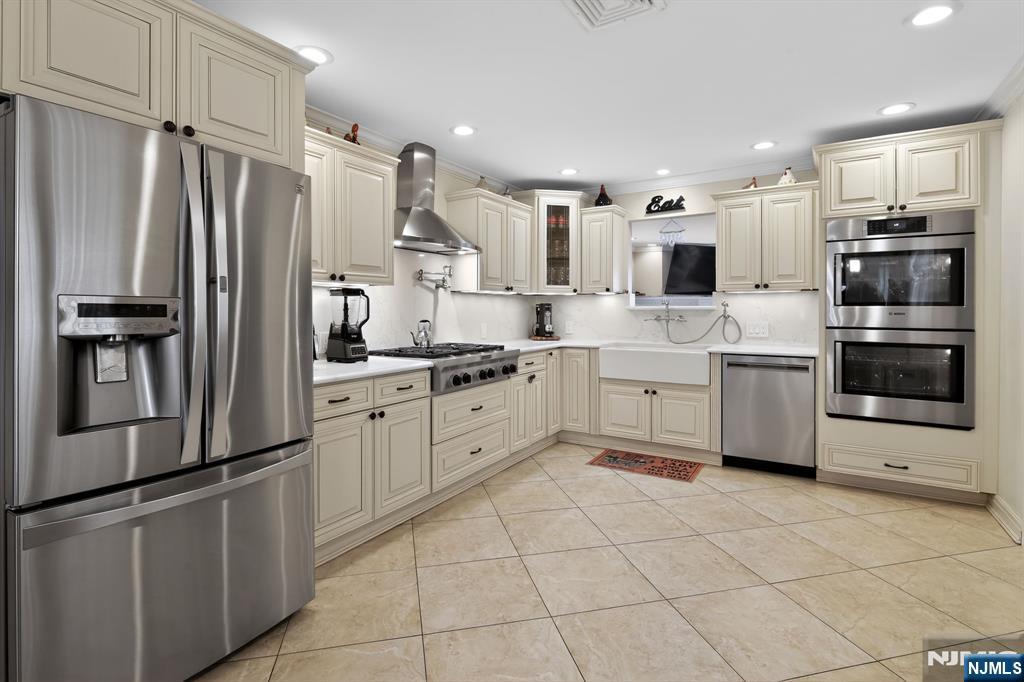 317 Ridge Road Rutherford, NJ 07070 - Photo 14 of 32 a kitchen with stainless steel appliances a refrigerator sink and microwave