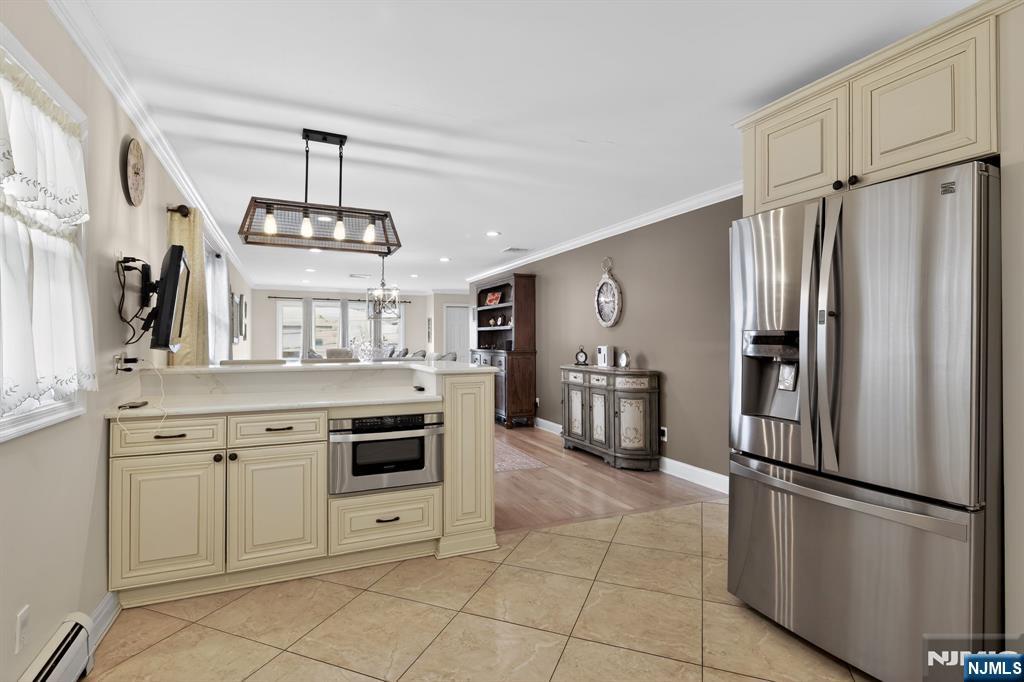 317 Ridge Road Rutherford, NJ 07070 - Photo 15 of 32 a kitchen with stainless steel appliances a refrigerator sink and cabinets