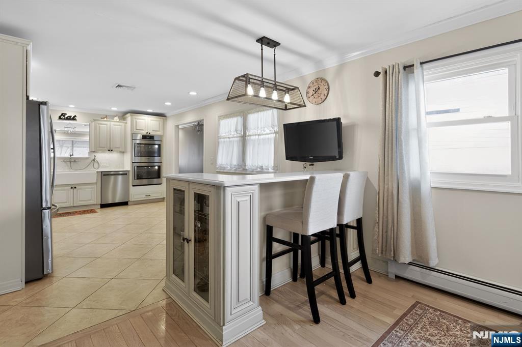 317 Ridge Road Rutherford, NJ 07070 - Photo 16 of 32 a view of kitchen with dining area refrigerator and wooden floor