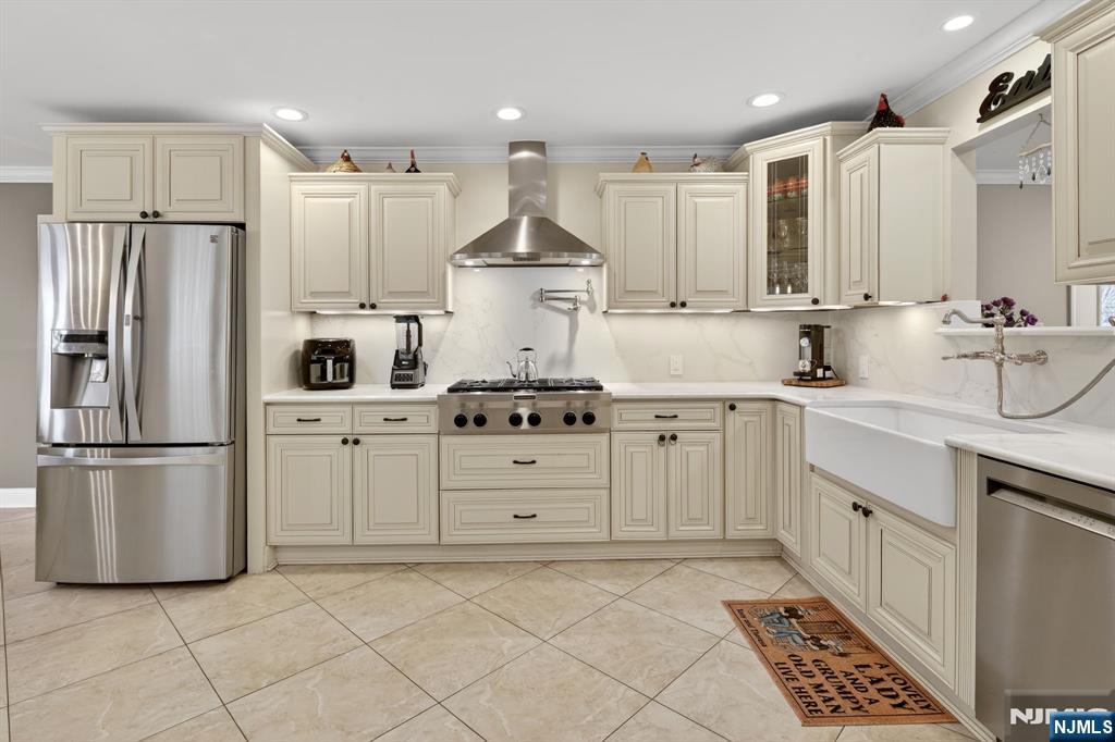 317 Ridge Road Rutherford, NJ 07070 - Photo 17 of 32 a kitchen with white cabinets and stainless steel appliances