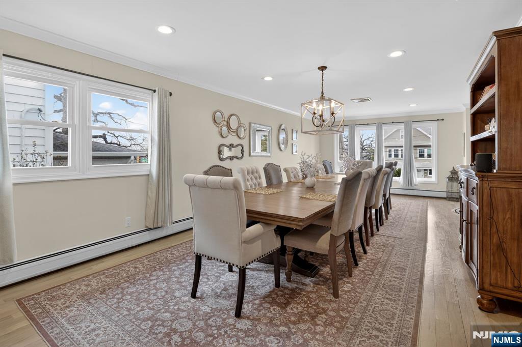 317 Ridge Road Rutherford, NJ 07070 - Photo 19 of 32 a dining room with furniture a chandelier and wooden floor