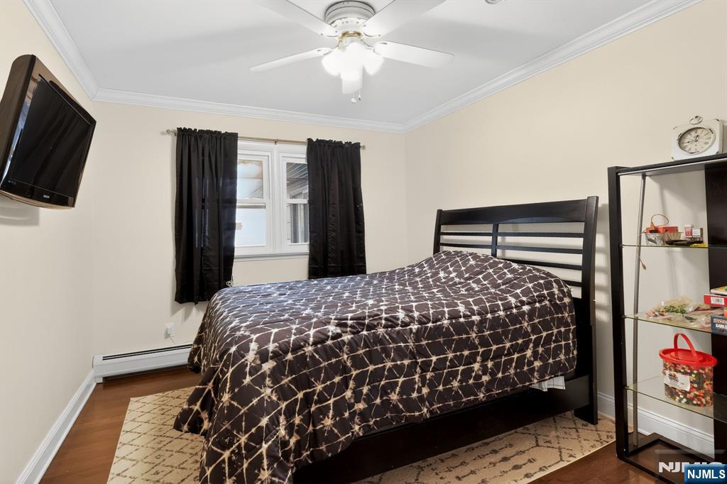 317 Ridge Road Rutherford, NJ 07070 - Photo 23 of 32 a bedroom with a bed and flat screen tv