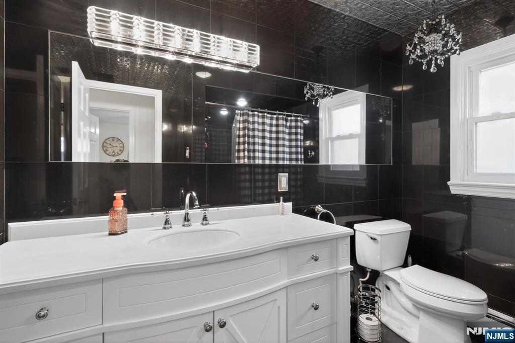 317 Ridge Road Rutherford, NJ 07070 - Photo 26 of 32 a bathroom with a sink toilet and a mirror