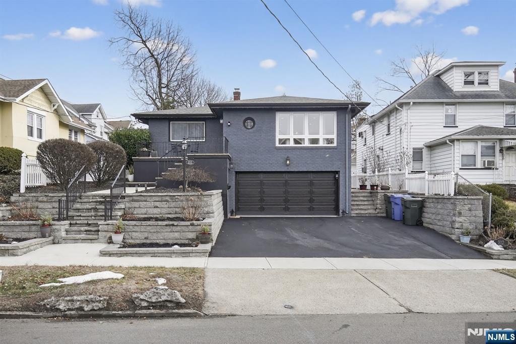 317 Ridge Road Rutherford, NJ 07070 - Photo 3 of 32 a front view of a house with a garage