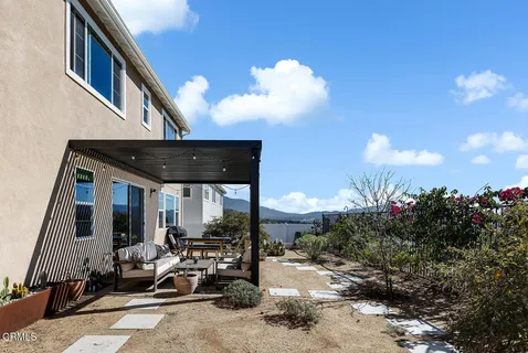 a view of a patio with table and chairs and potted plants