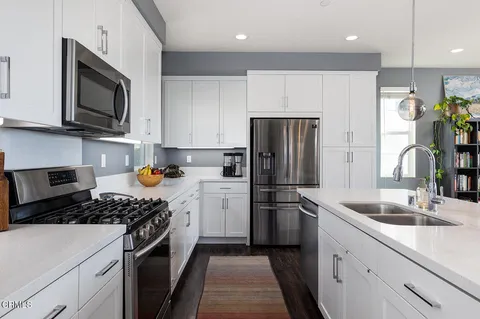 a kitchen with a refrigerator stove and microwave