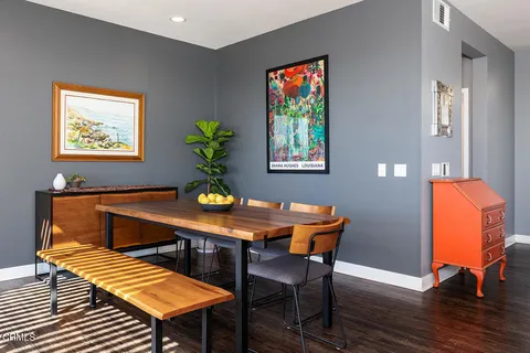 a view of a dining room with furniture and wooden floor