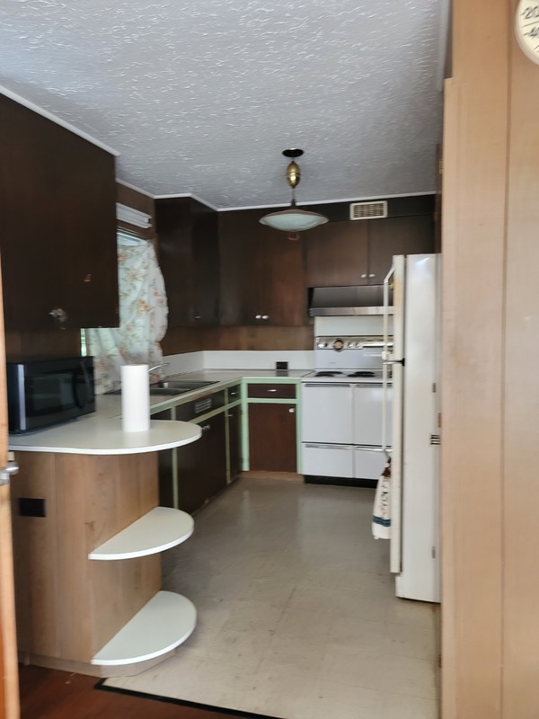 81-1048 Captain Cook Road Captain Cook, HI 96704 - Photo 3 of 10 a kitchen with a stove and a refrigerator