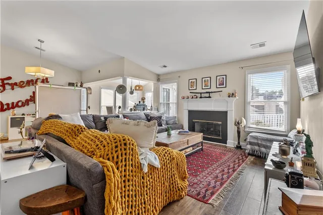 a living room with furniture fireplace and a large window