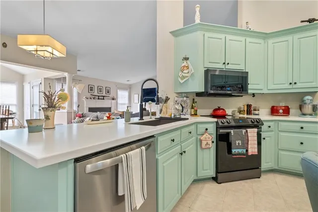 a kitchen with a sink cabinets and a wooden floor