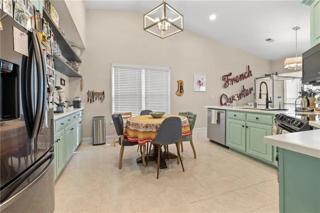 a view of a dining room with furniture and a kitchen