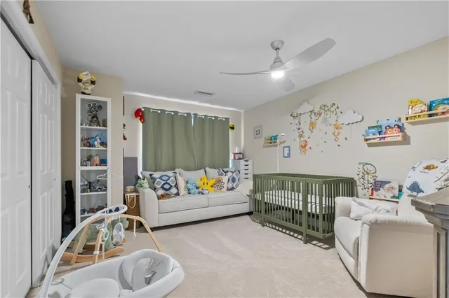 a bedroom with a bed and a baby bed