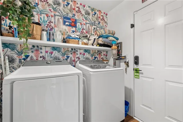 a view of a brick house with large windows and a yard