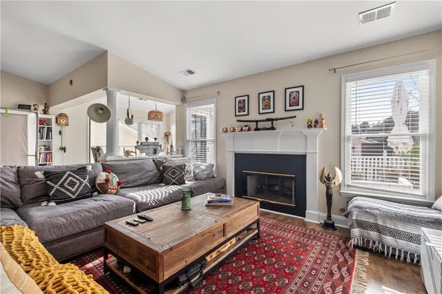 a living room with furniture and a fireplace