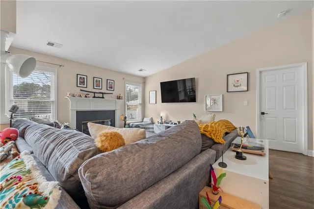 a living room with furniture fireplace and a flat screen tv