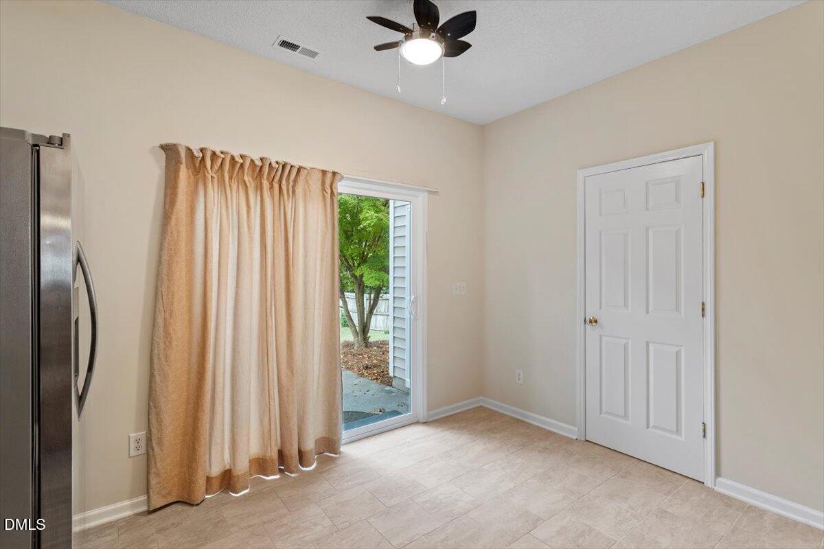 1039 Dual Parks Road Apex, NC 27502 - Photo 18 of 46 an empty room with window and a ceiling fan