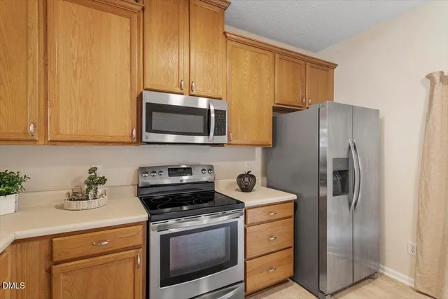a kitchen with stainless steel appliances granite countertop a sink and a white cabinets
