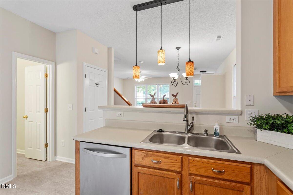 1039 Dual Parks Road Apex, NC 27502 - Photo 20 of 46 a kitchen with stainless steel appliances granite countertop a sink and a white cabinets